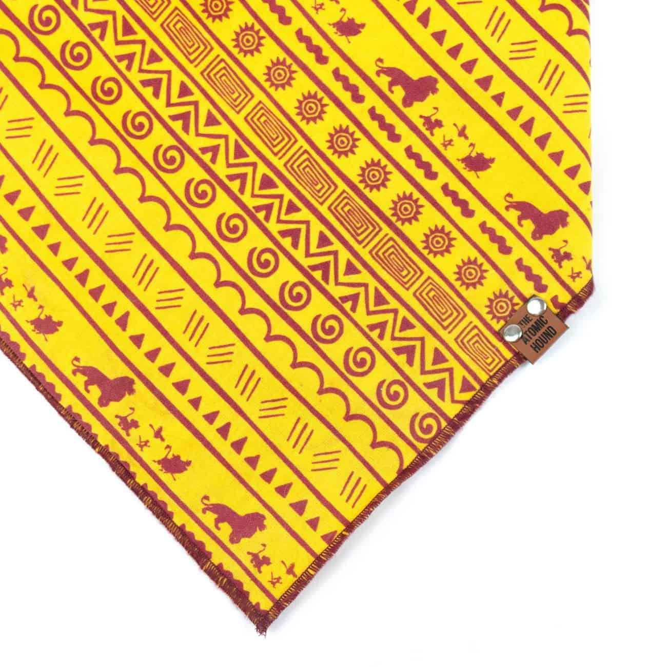Yellow and maroon dog bandana with Lion King character pattern